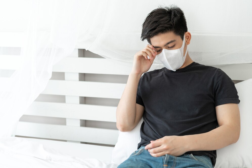 Asian man wearing face mask protect feeling sick headache cough because coronavirus covid 19 quarantine room 1150 35772